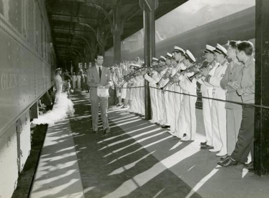 A military band salutes Cary Grant