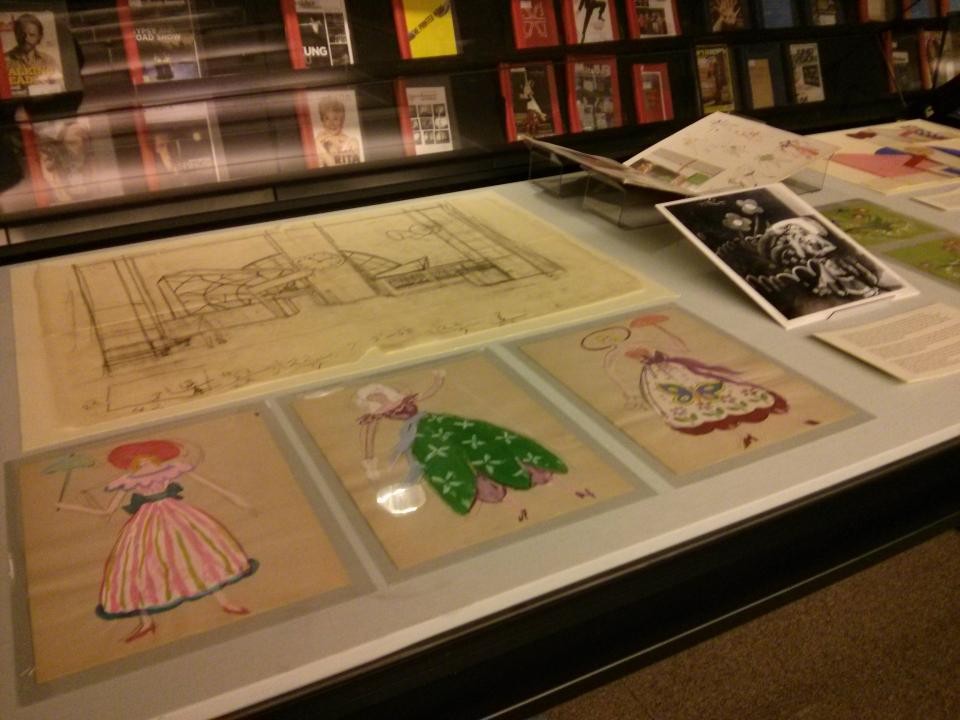 Image of exhibit cases with dance designs.