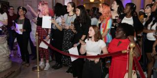 Photo from NYPL's Anti-Prom featuring a crowd of teens behind a red velvet rope