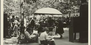 Black and white photo of people reading in Bryant Park.
