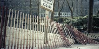 Wooden fencing at Bryant Park entrance with a sign reading "Entrance Temporarily Closed."