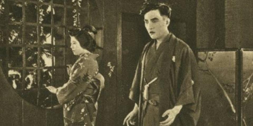 still from a movie showing an Asian man and woman