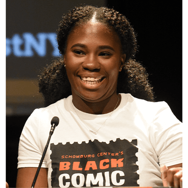 Head shot of Kadiatou Tubman wearing a Black Comic Festival T-shirt. She is standing at a podium on a microphone.