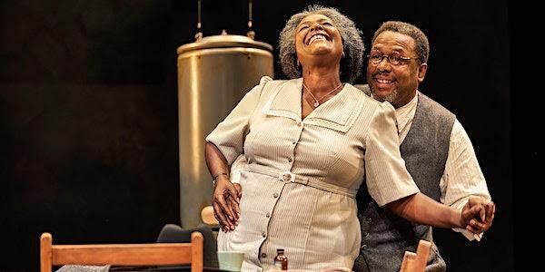 Actors Sharon D. Clarke and Wendell Pierce are onstage. Piece is standing behind Clarke with his hand holding her waist on the left and her hand on the right side. 