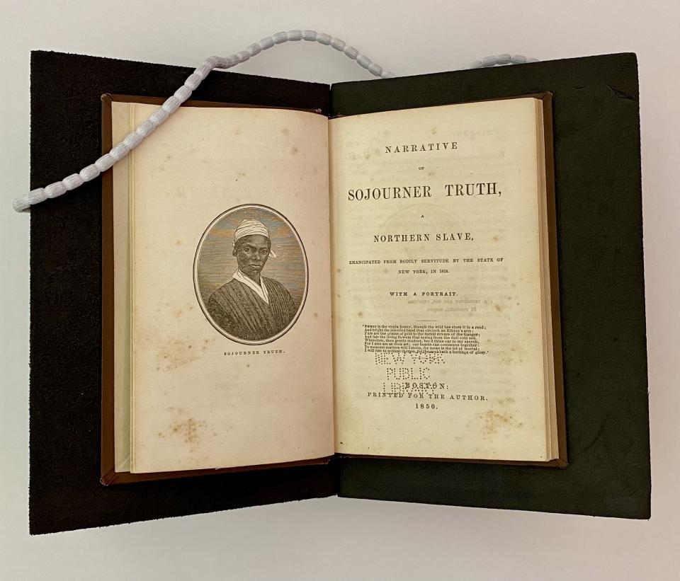 The inside title of the book, Narrative of Sojourner Truth. The book is open and sitting on black foam cradle. There is a white chain on the upper left-hand corner holding down a page of the book.
