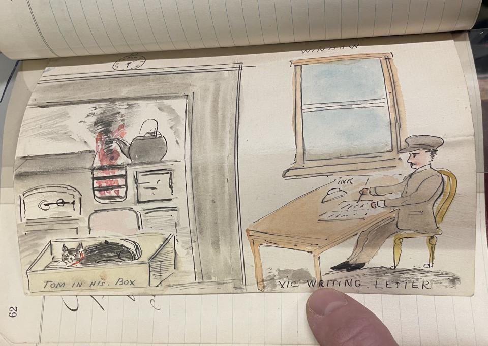 A drawing in a book that shows a boy sitting at a table writing a letter, next to a stove and a cat sleeping in a box