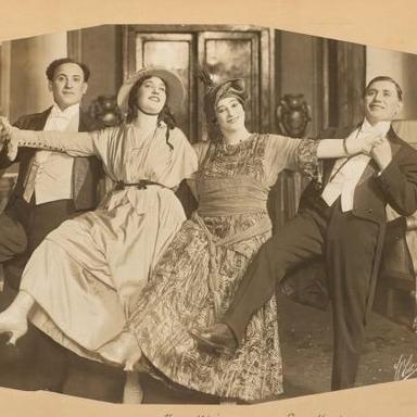 two men and two women dancing together