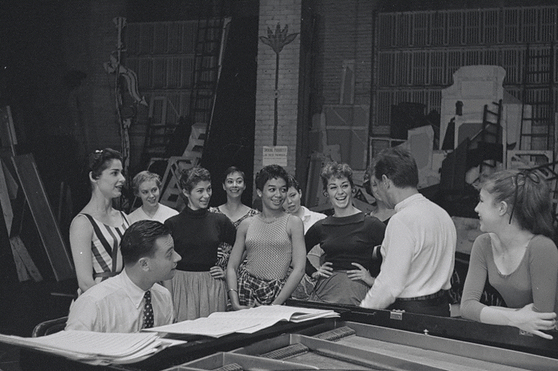 Bernstein conducts music rehearsal while Sondheim accompanies on the piano. Photo by Martha Swope.