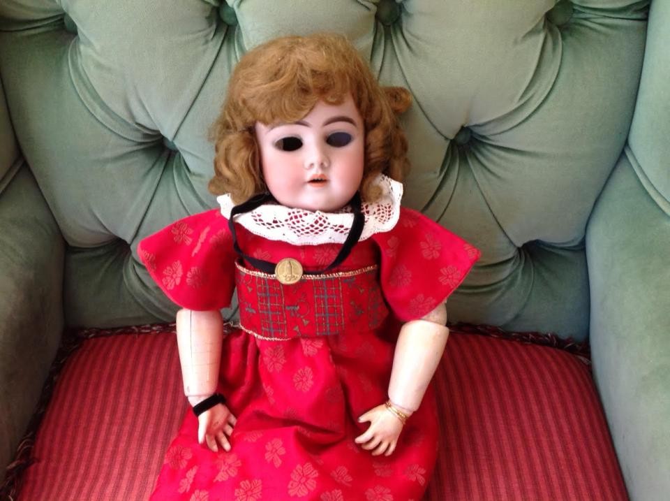 Annie Carlsson's doll wearing a button from her father's uniform.  Collection of the National Lighthouse Museum.