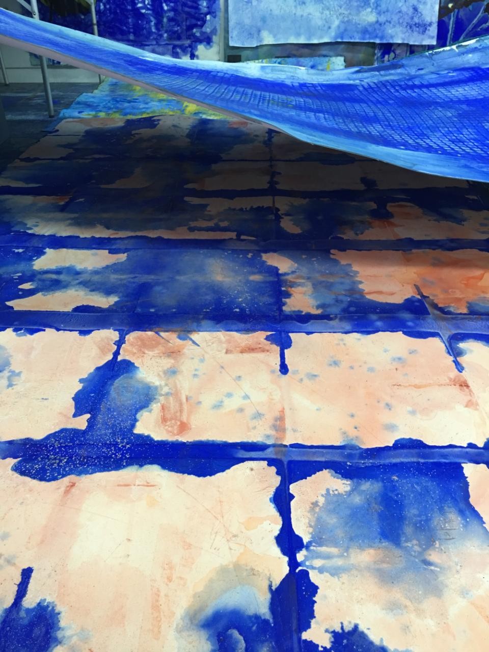 studio floor painting of blue blotches