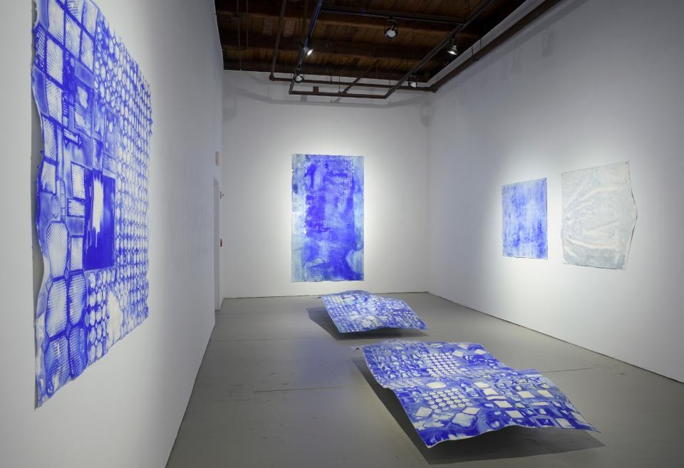 gallery view of blue paintings on a wall