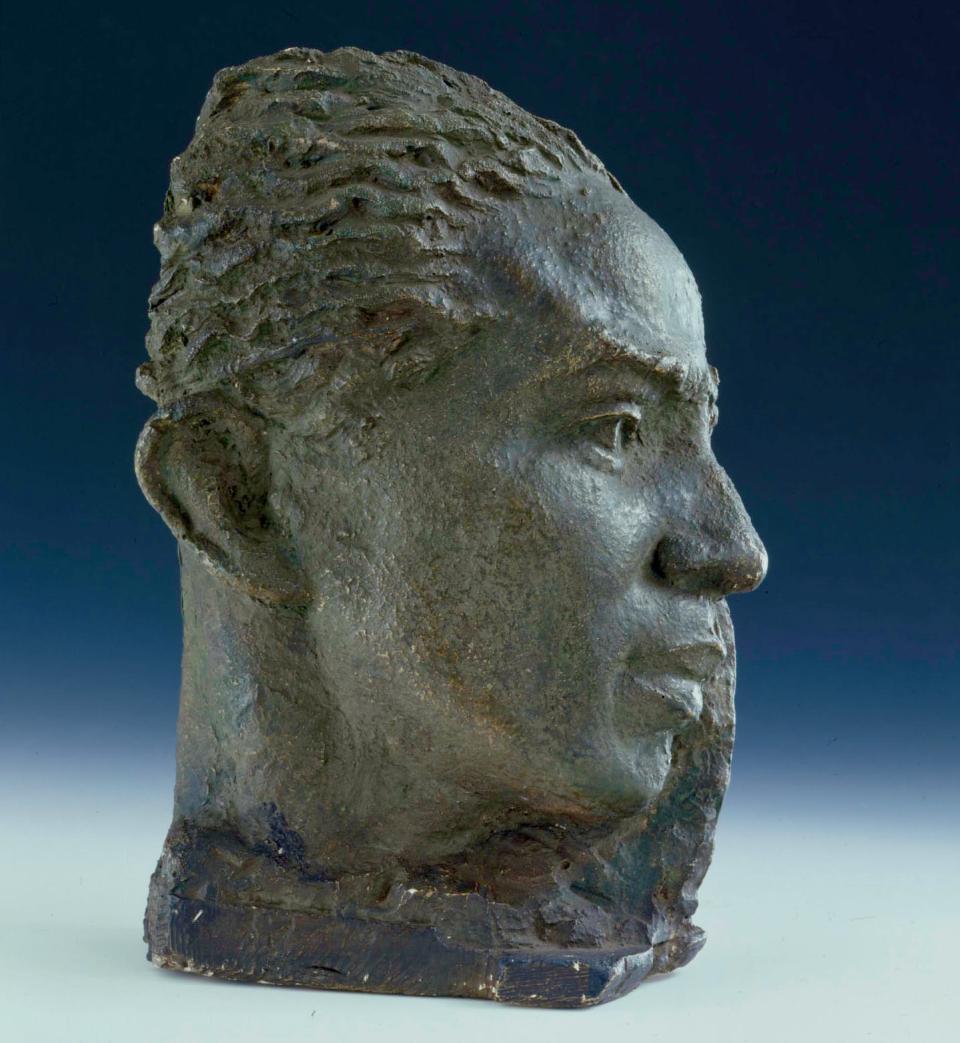 A bust of poet and author Langston Hughes against a blue background