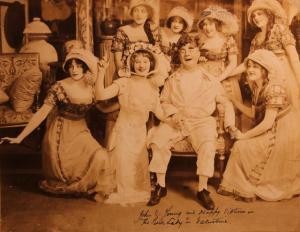 John E. Young as Dondidier surrounded by the women of the cast (MWEZ +nc7197)