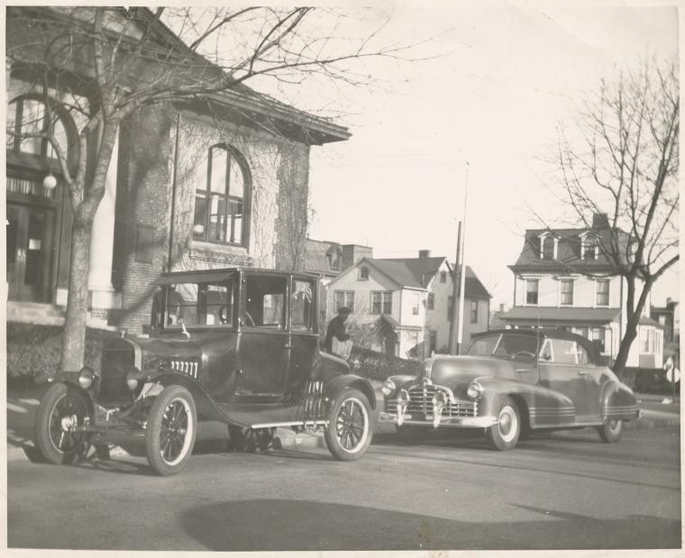 [Port Richmond] Staff member's Pontiac convertible, Reader's Ford, Mr. Krant, news dealer on sidewalk, Digital ID 1253038, New York Public Library
