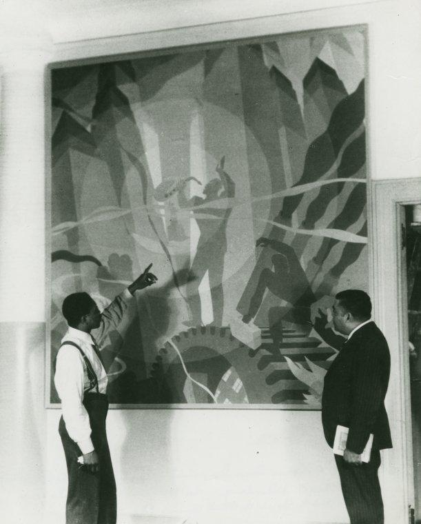 Artist Aaron Douglas and Arturo Schomburg in front of Douglas' painting