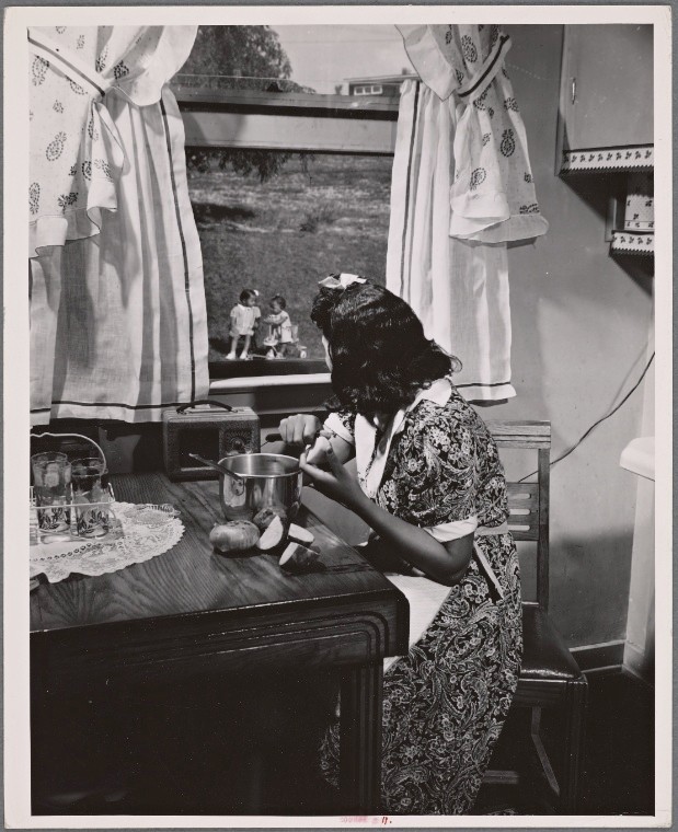 Farm Security Adminstration photograph of an Anacostia, D.C. mother watching her children out the window as she prepares a meal. Gordon Parks, 1942, image ID 3969615