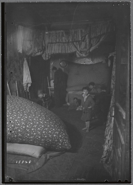Windowless room interior with adult and three children
