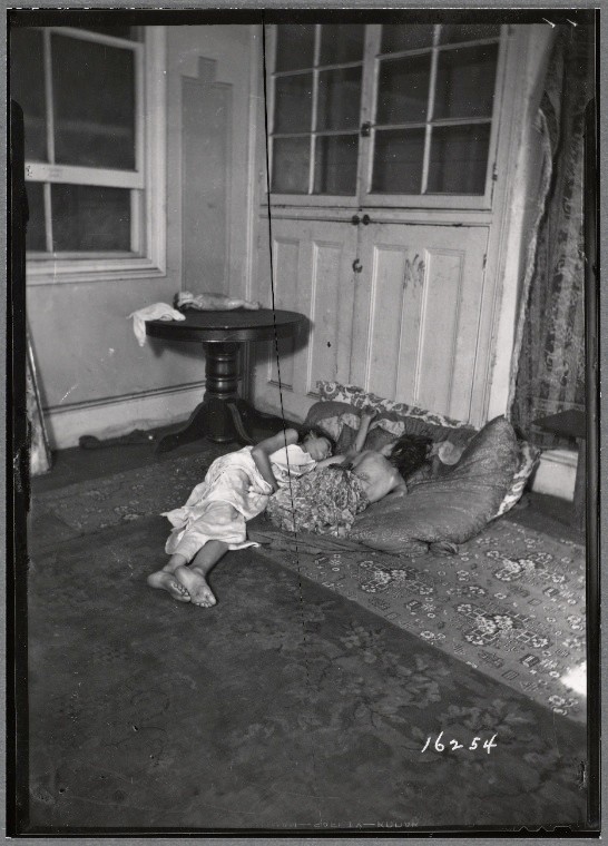 Interior view with two children sleeping on cushions on floor