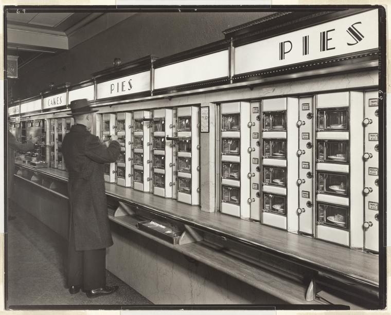 Man standing at pie dispenser counter at an automat