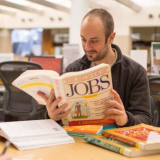 Man reading The Big Book of Jobs 