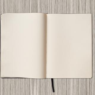 empty notebook with pen and pencil to the right
