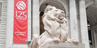 Lion statue in front of red banner