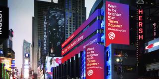 Image of screens in Times Square encouraging people to get a library card