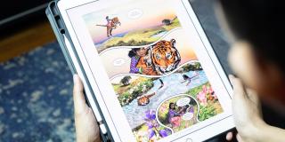 Teen reading graphic novel on iPad