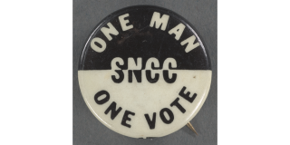 Photograph of a black and white button that reads: One Man One Vote SNCC