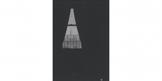 Historic photo of the Empire State Building as seen through the window of a dark room with curtains