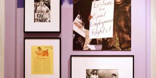 three framed items and one larger, photo print of a black woman holding a sign at a protest