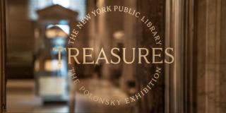 Glass door with gold logo of Treasures exhibition displayed on it