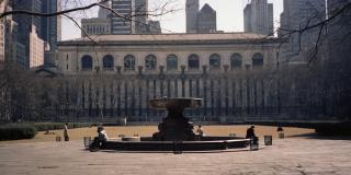 Bryant Park fountain with the Stephen A. Schwarzman Building in the background.