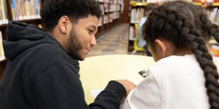 A Teen Reading Ambassador tutors a younger student.