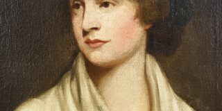 Portrait of a woman with rosy cheeks gazing to the left, wearing a white blouse.