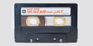 A cassette tape with orange handwritten text on the label reading: "Wild Style: Hip Hop Rap music in N.Y."