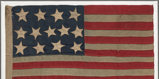 A worn American flag with 13 stars and 13 stripes, made for and carried by Jack London during the Russo-Japanese War