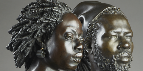 Detail of two bronze sculptures of an African man and woman by Charles Henri Joseph Cordier 