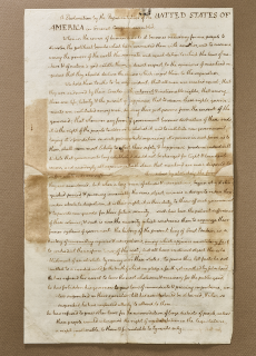 Thomas Jefferson’s handwritten copy of the Declaration of Independence; paper is browned and folded with script handwriting