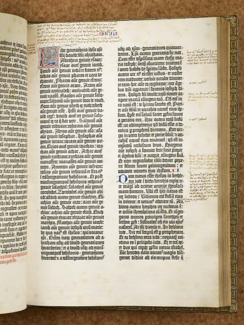 Book displayed open to show closely printed text in Latin in two columns