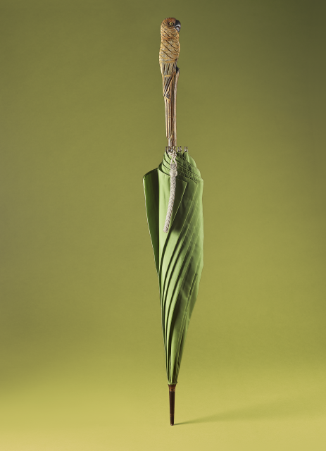 Photo of a green umbrella with a bird-shaped wooden handle that belonged to Mary Poppins author P.L. Travers.