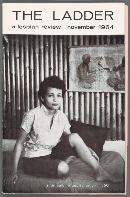 A magazine with a short-haired woman sitting on a bed with one leg folded underneath the other