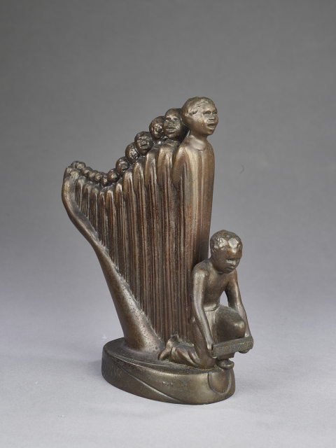 Small bronze model of a larger sculpture called Lift Every Voice and Sing (Harp), which features a line of people of various heights standing close together so they resemble a harp. 