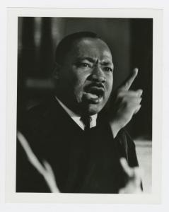 A black and white photograph shows Dr. Martin Luther King Jr. 