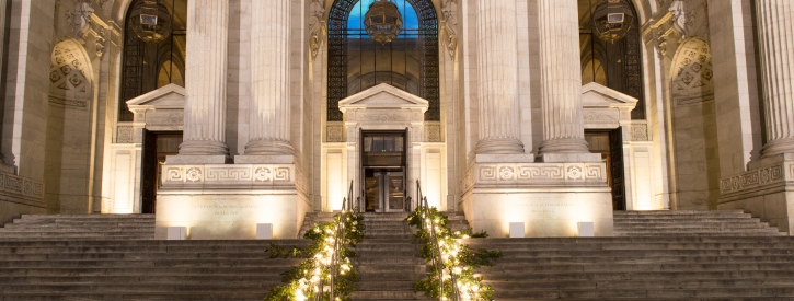 Exterior steps of Stephen A. Schwarzman Building lit with candles and vines